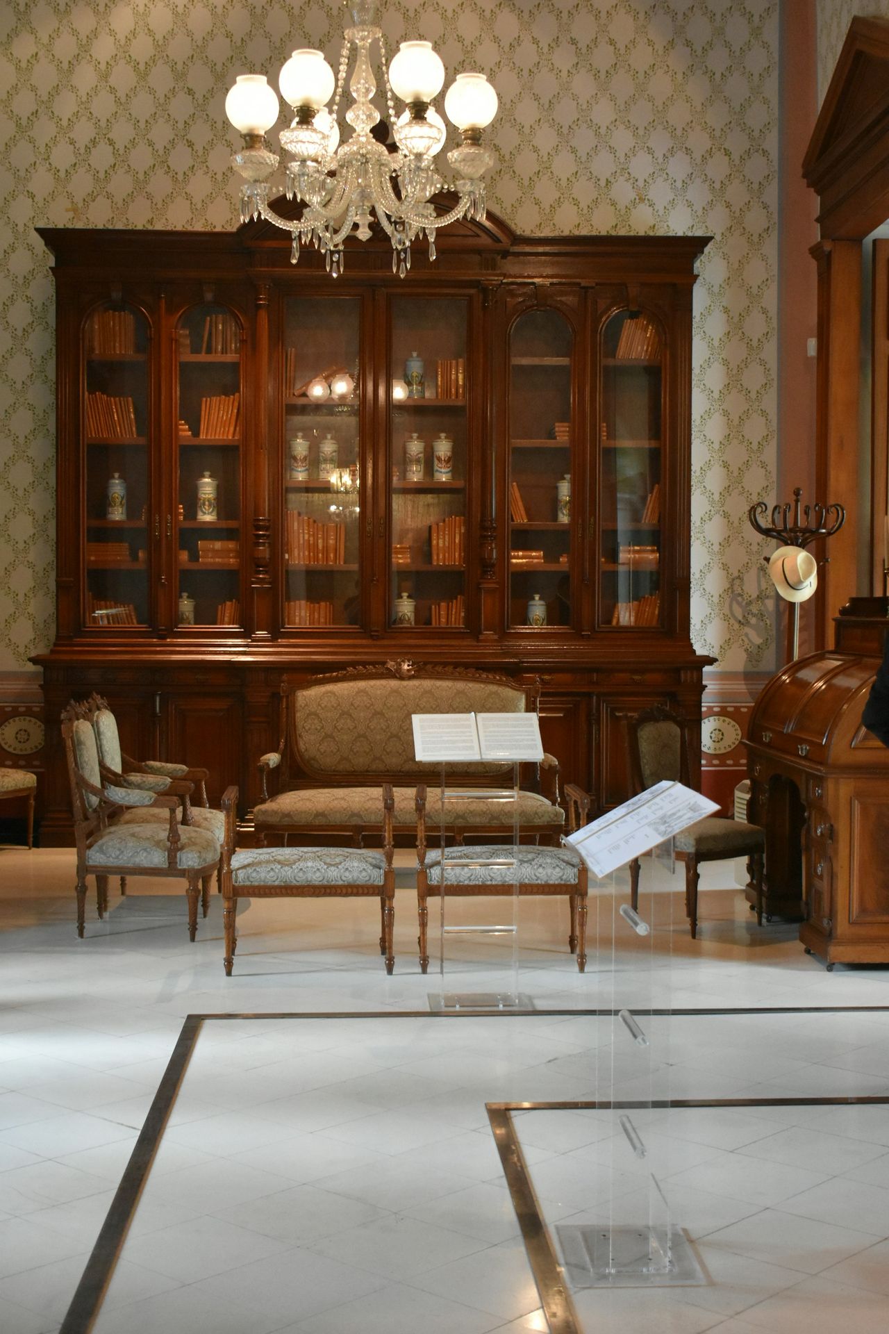 a room with a piano and chairs